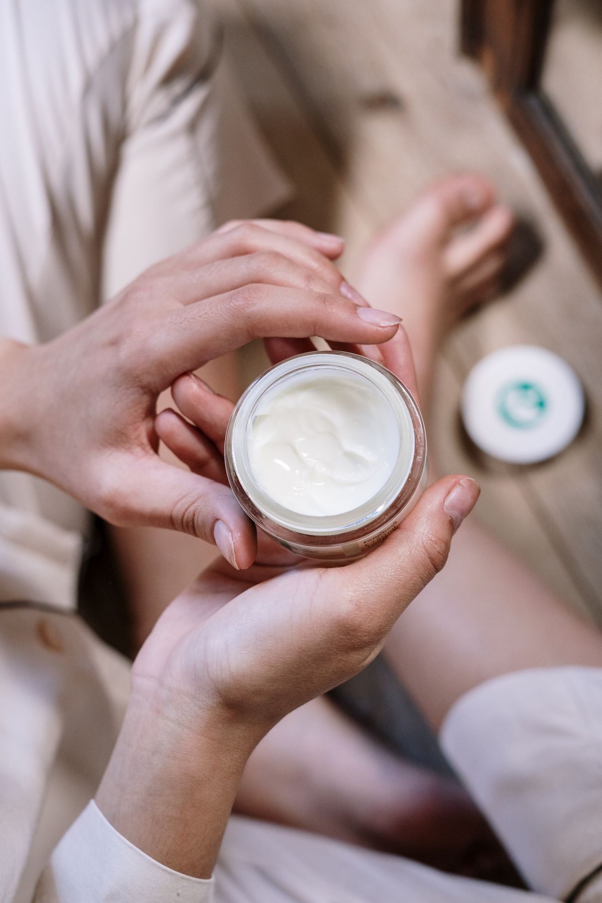 A parent carefully reading the label on a skincare bottle