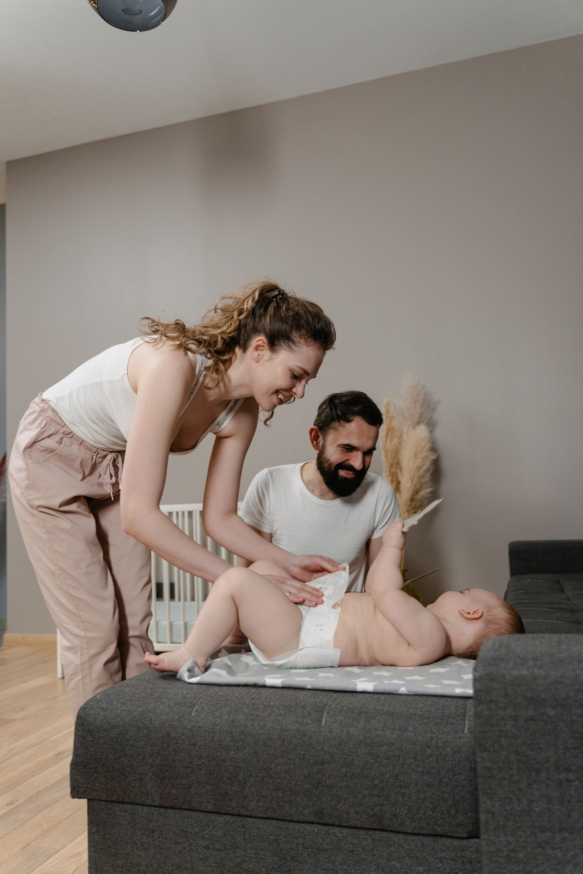 Parents caring for their baby during a nappy change